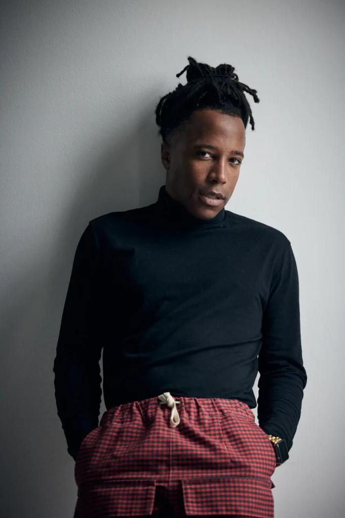 Chad Chambers wearing a black turtleneck and red patterned pants